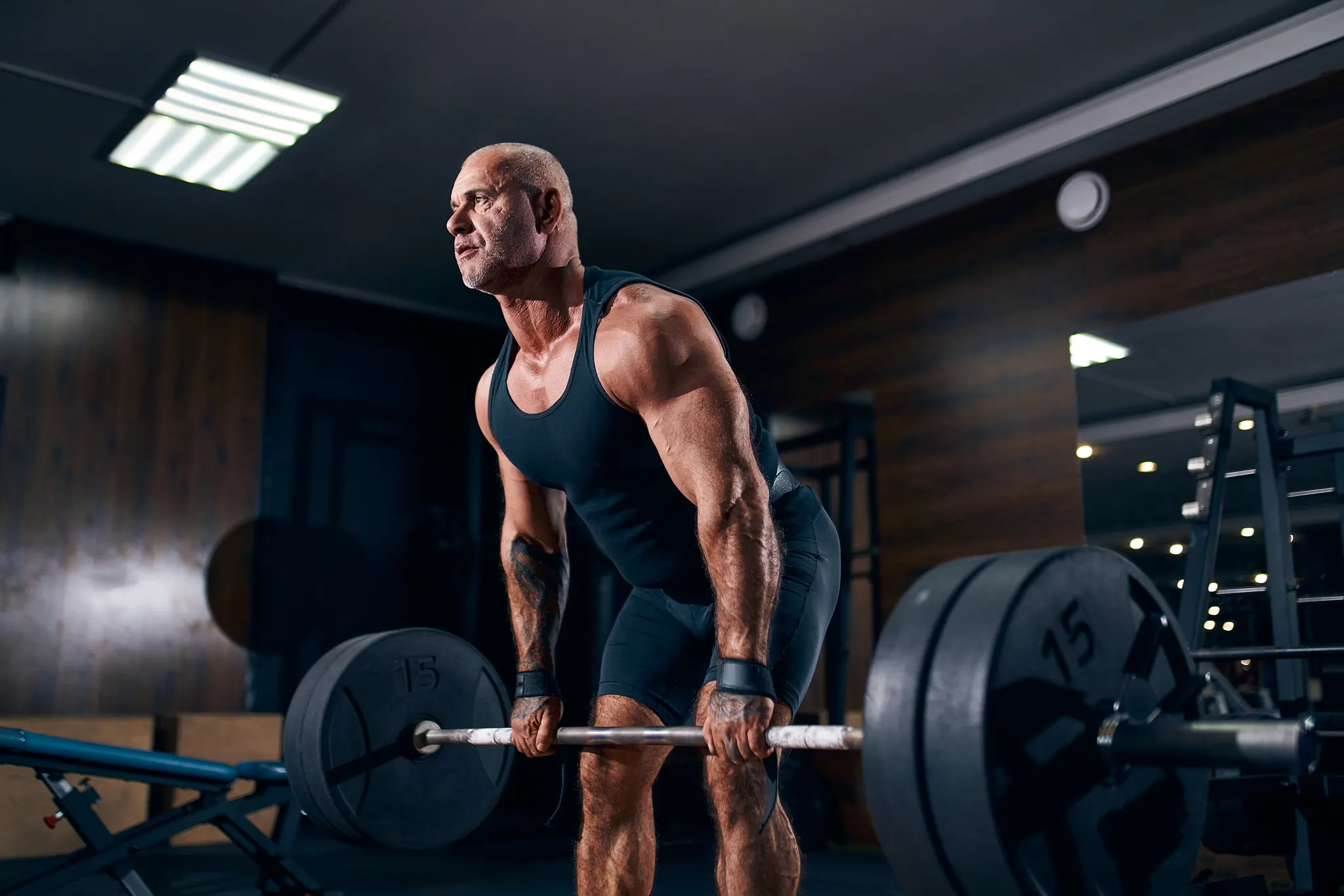 Man mid-deadlift in a gym