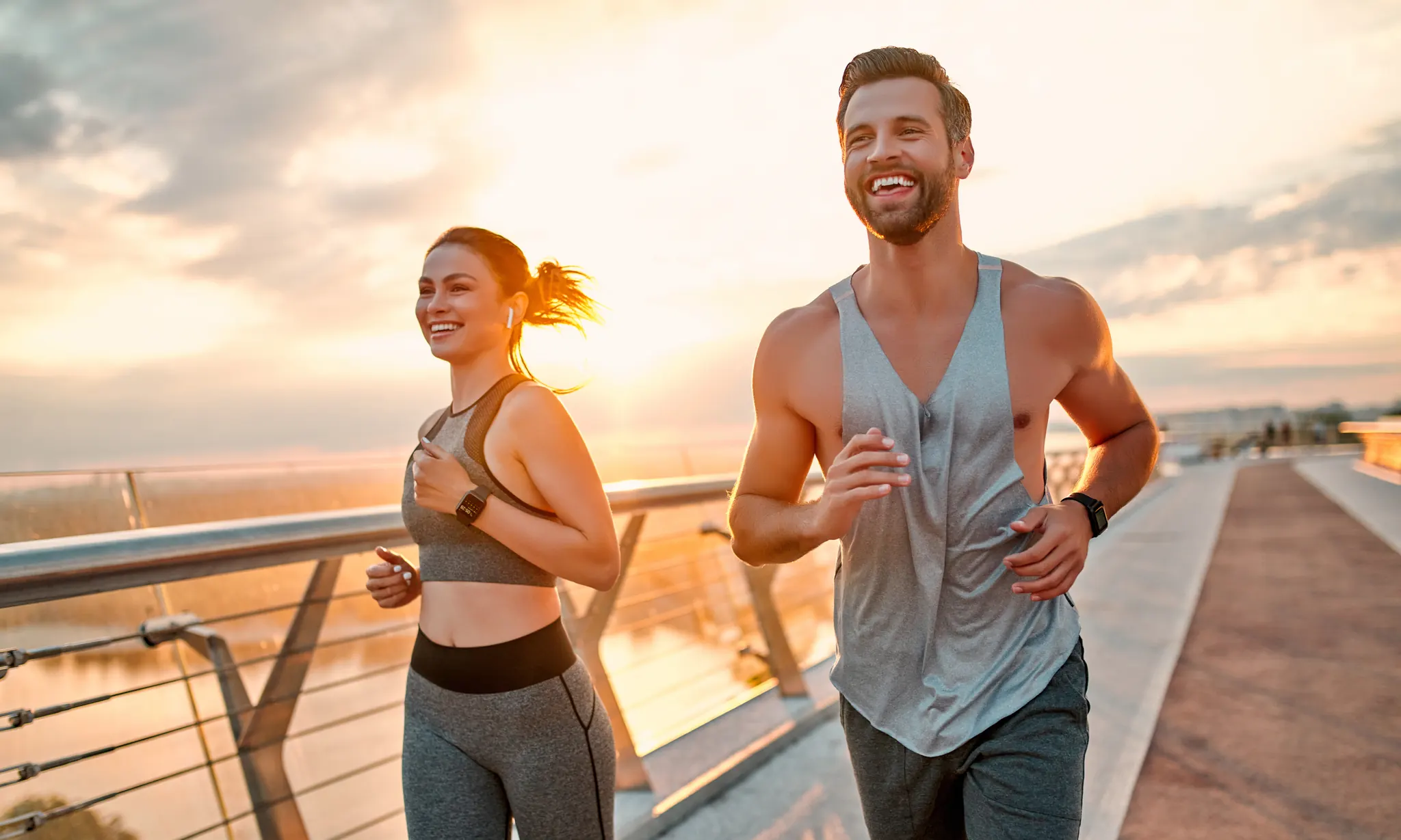 Man and woman jogging together at sunrise